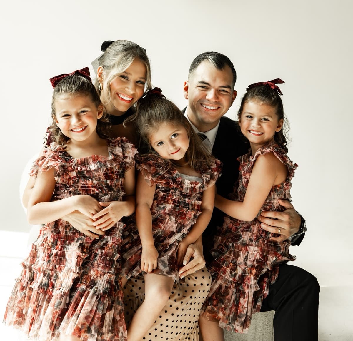 Carlos Bedoya with family, a holiday portrait against a white wall