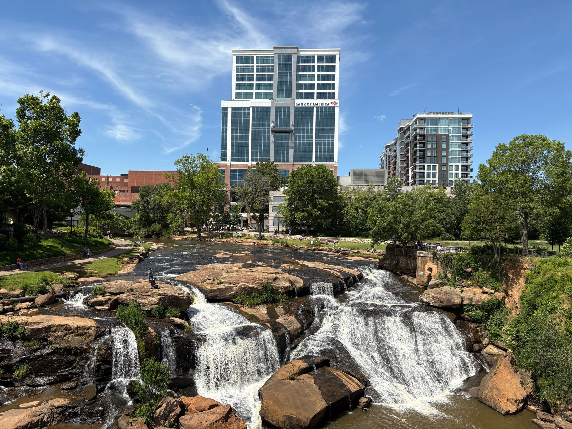 Reedy River Falls in Falls Park with the downtown Greenville skyline behind it